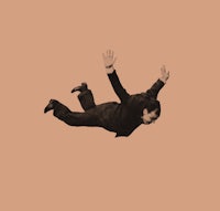 a man in a suit flying through the air